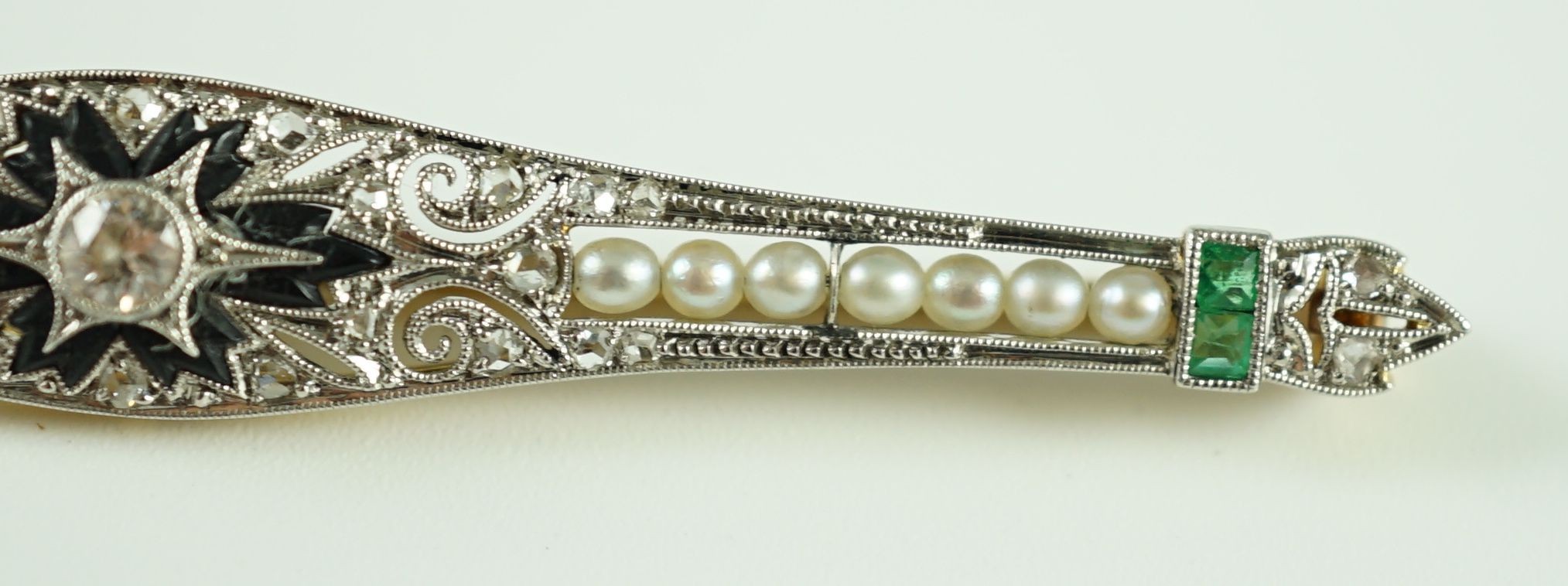 A 1920's gold and platinum, emerald, seed pearl, diamond and black onyx set bar brooch